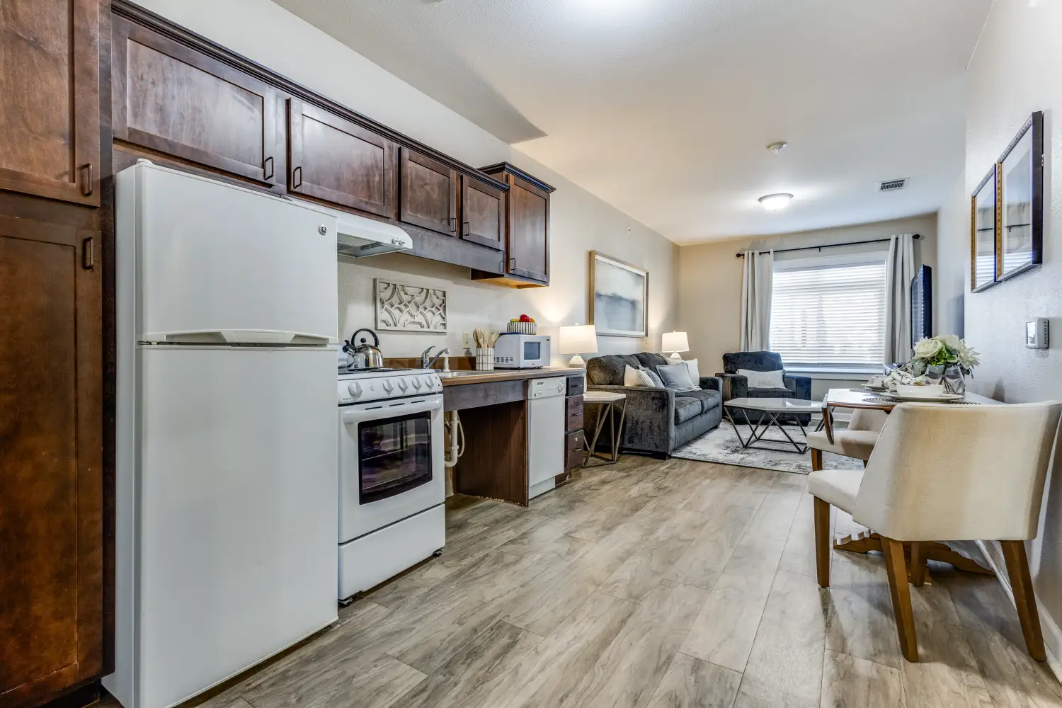 Senior living apartment kitchenette and living room at The Ivy of McKinney assisted living community Texas