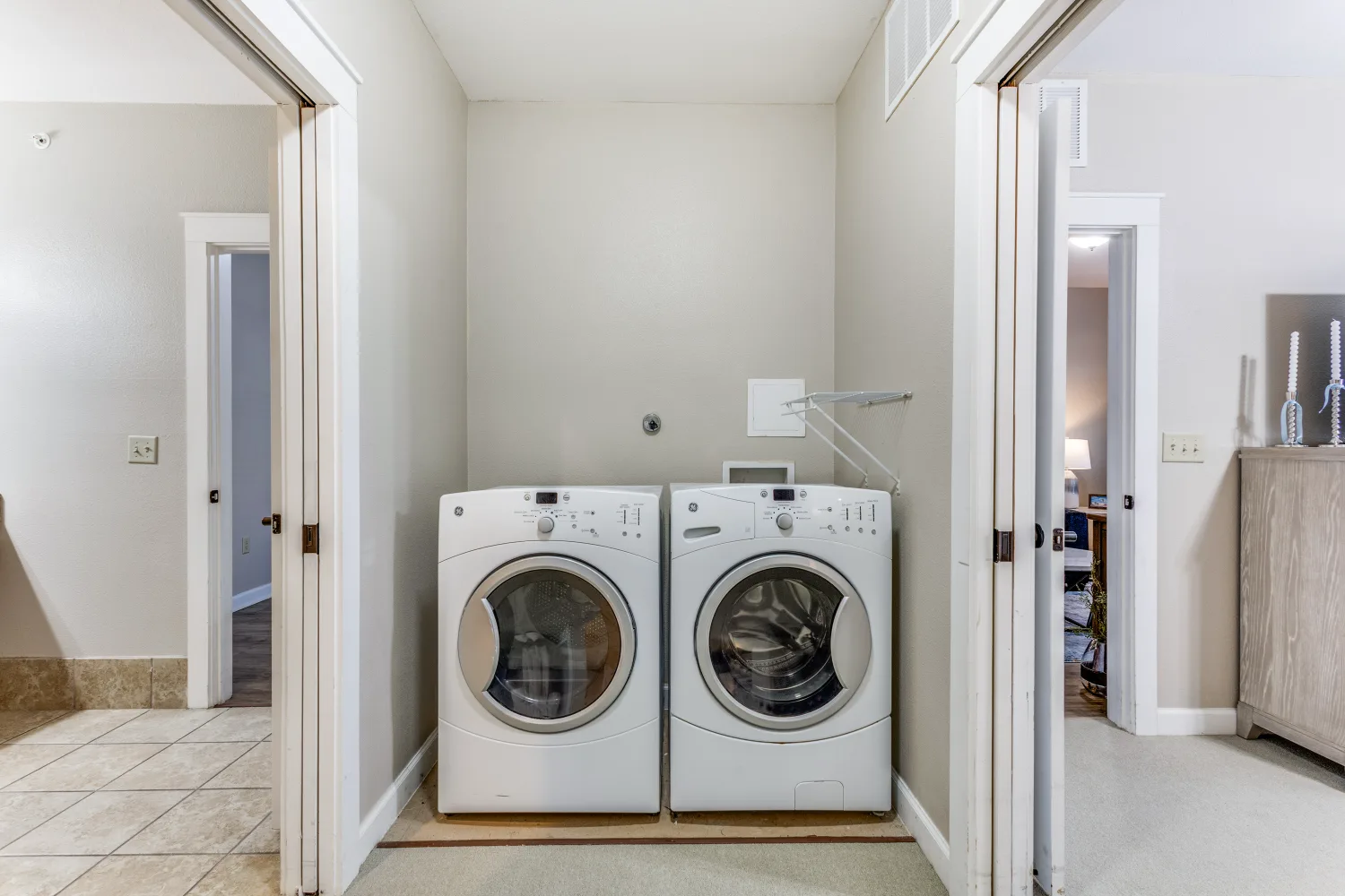 Senior living apartment laundry area with washer and dryer at The Ivy of McKinney assisted living community Texas