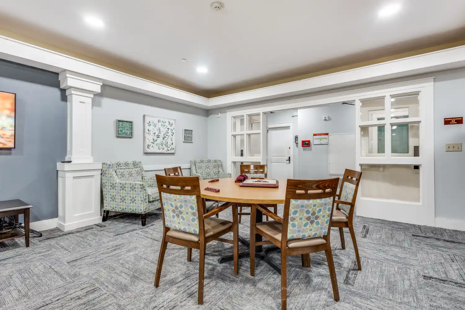 Senior living community game room with table seating and board games at The Ivy of McKinney assisted living Texas