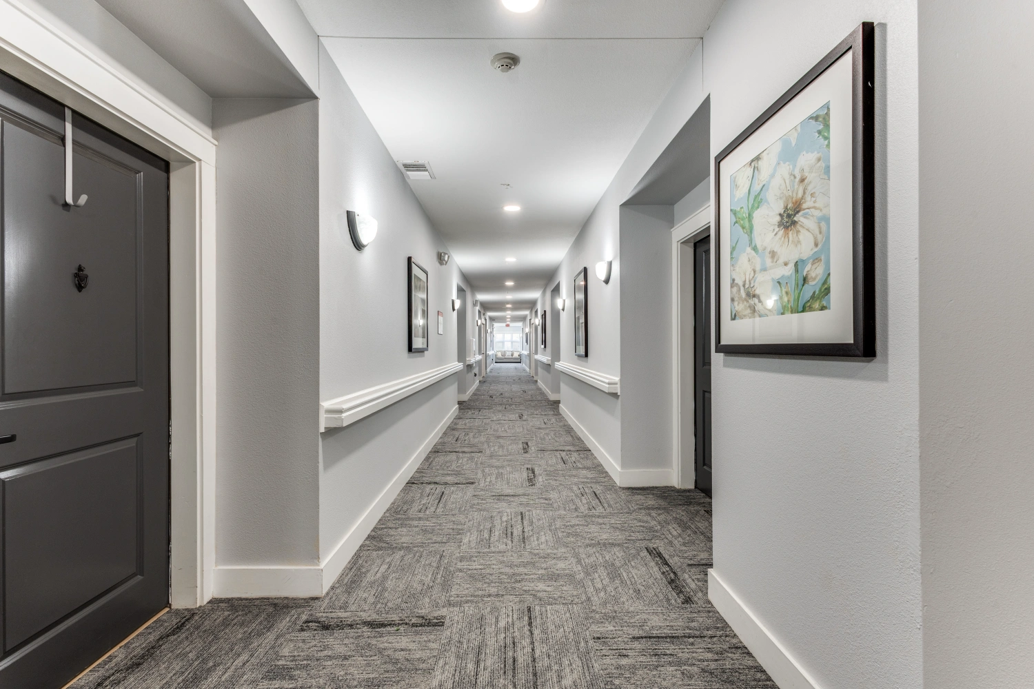 Senior living community hallway with resident apartments at The Ivy of McKinney assisted living in McKinney Texas
