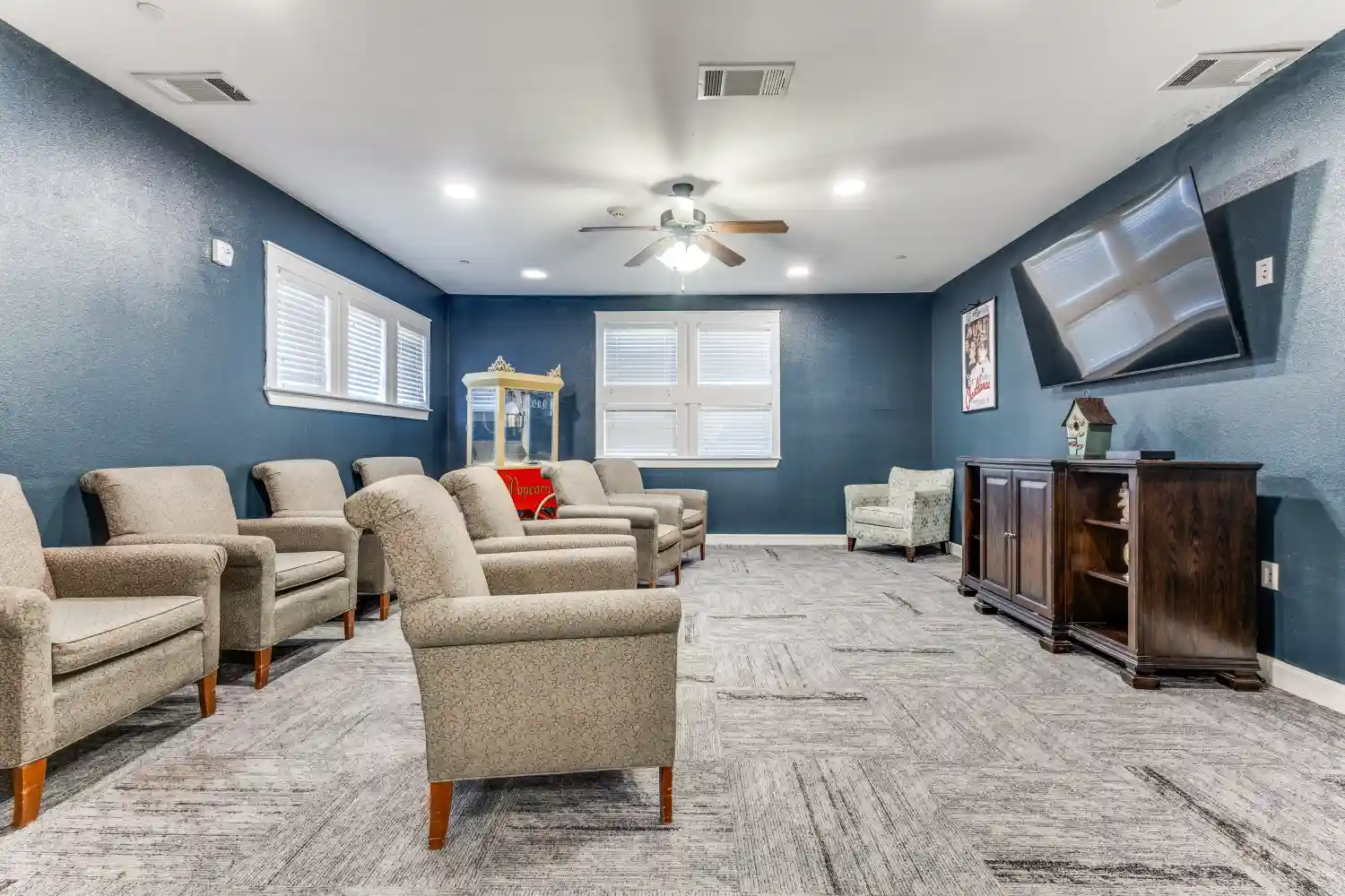 Senior living community theater room with seating and television at The Ivy of McKinney assisted living Texas